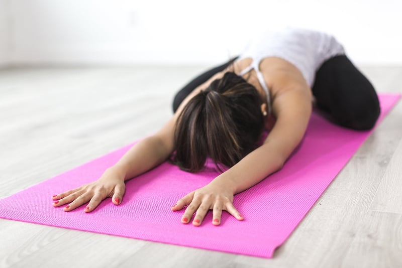 Woman practicing Vinyasa Flow yoga